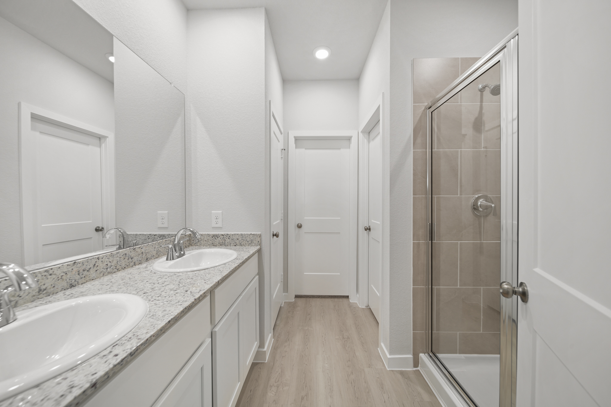 A bathroom with a sink and a shower.