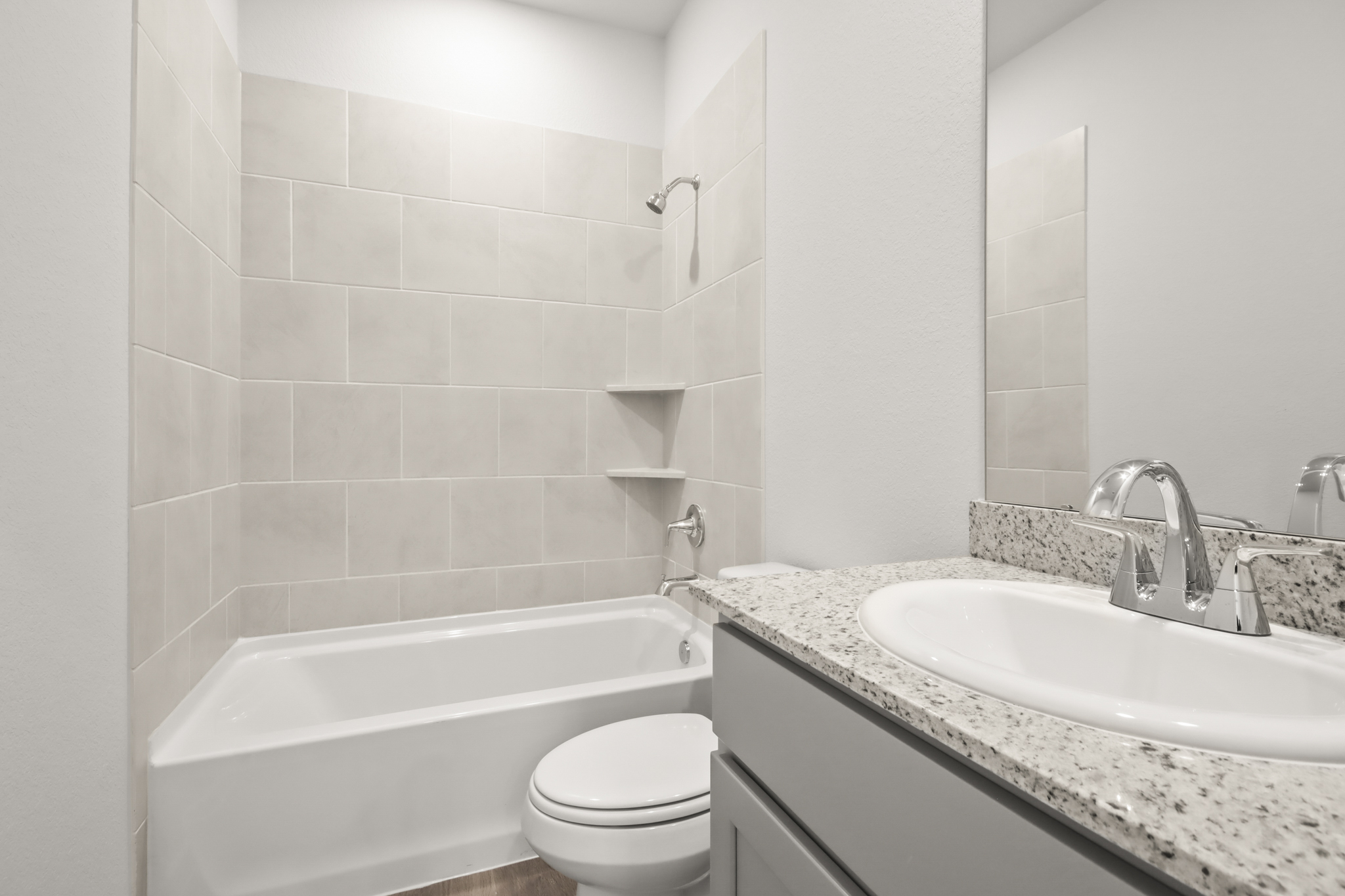 A bathroom with a tub sink and toilet.