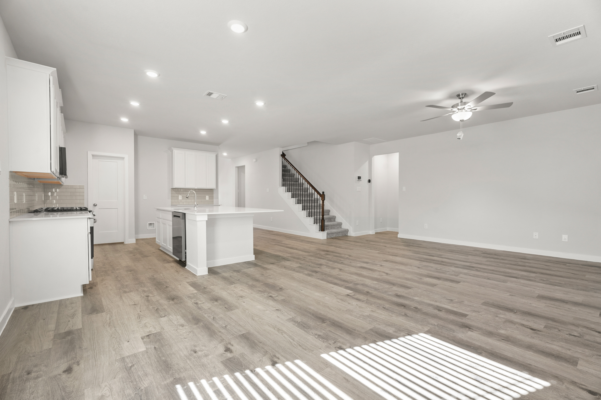 A large kitchen with white cabinets.
