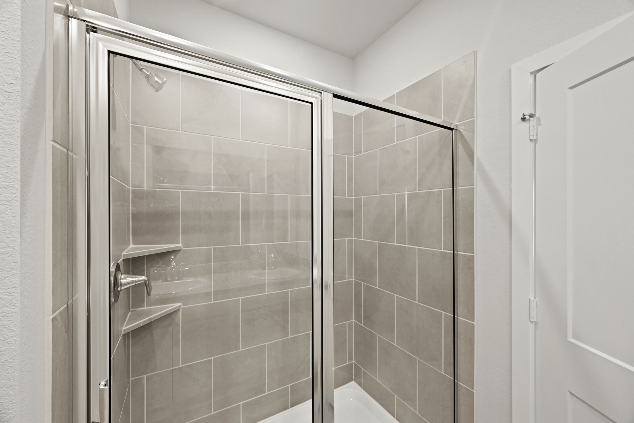 A shower with a glass door.