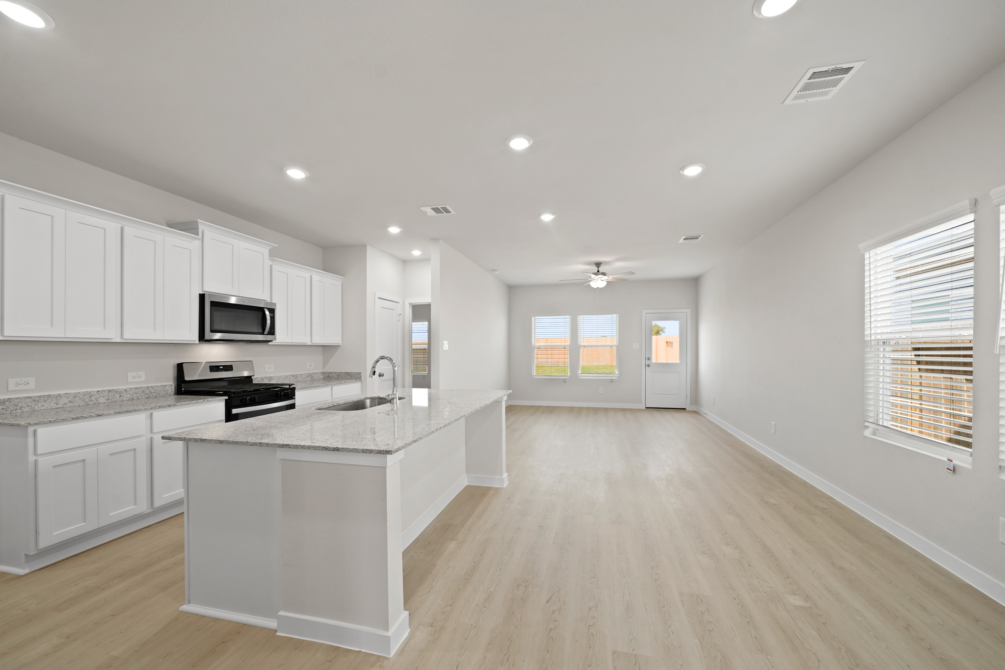 A kitchen with white cabinets.