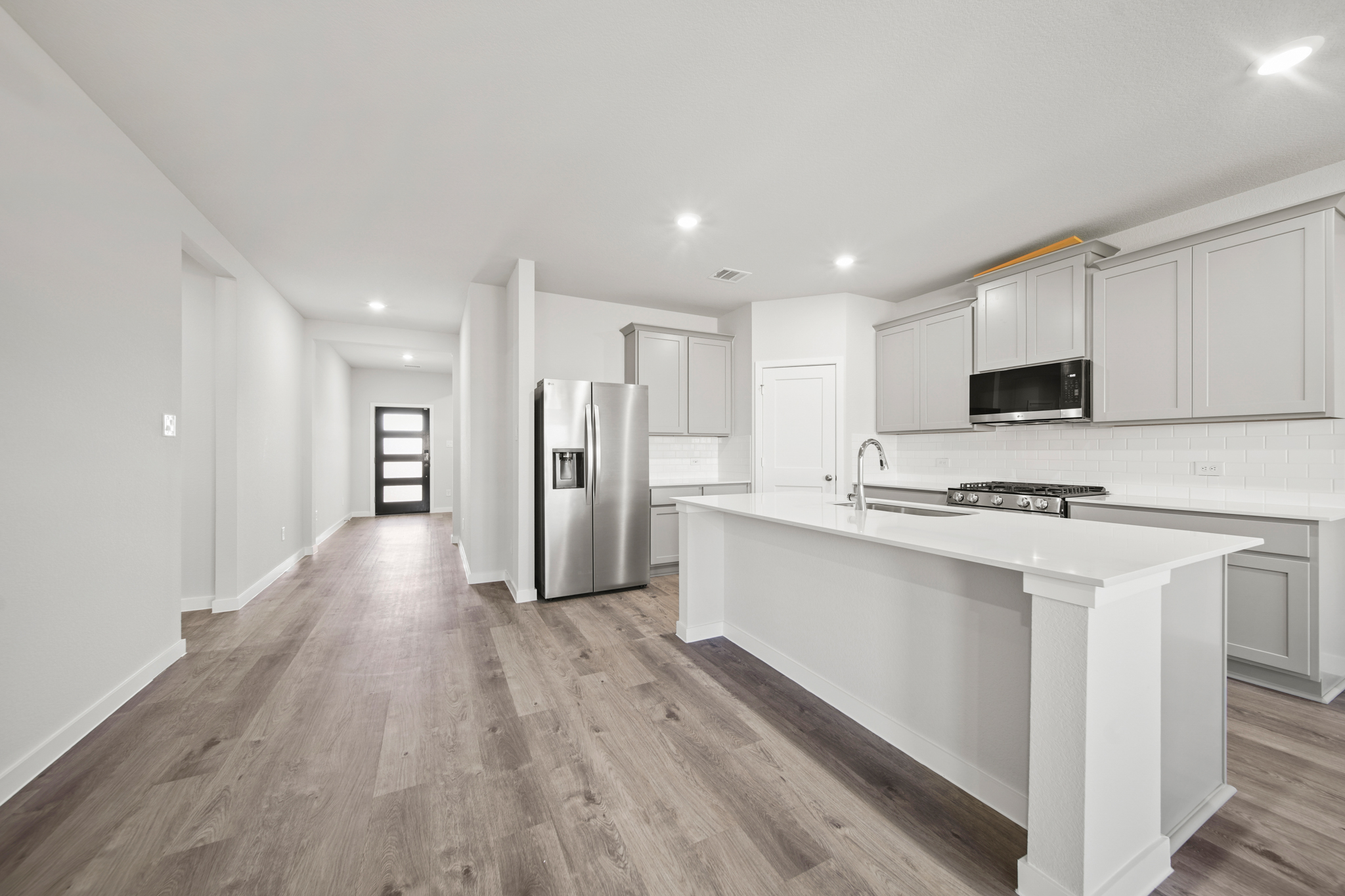 A kitchen with white cabinets.