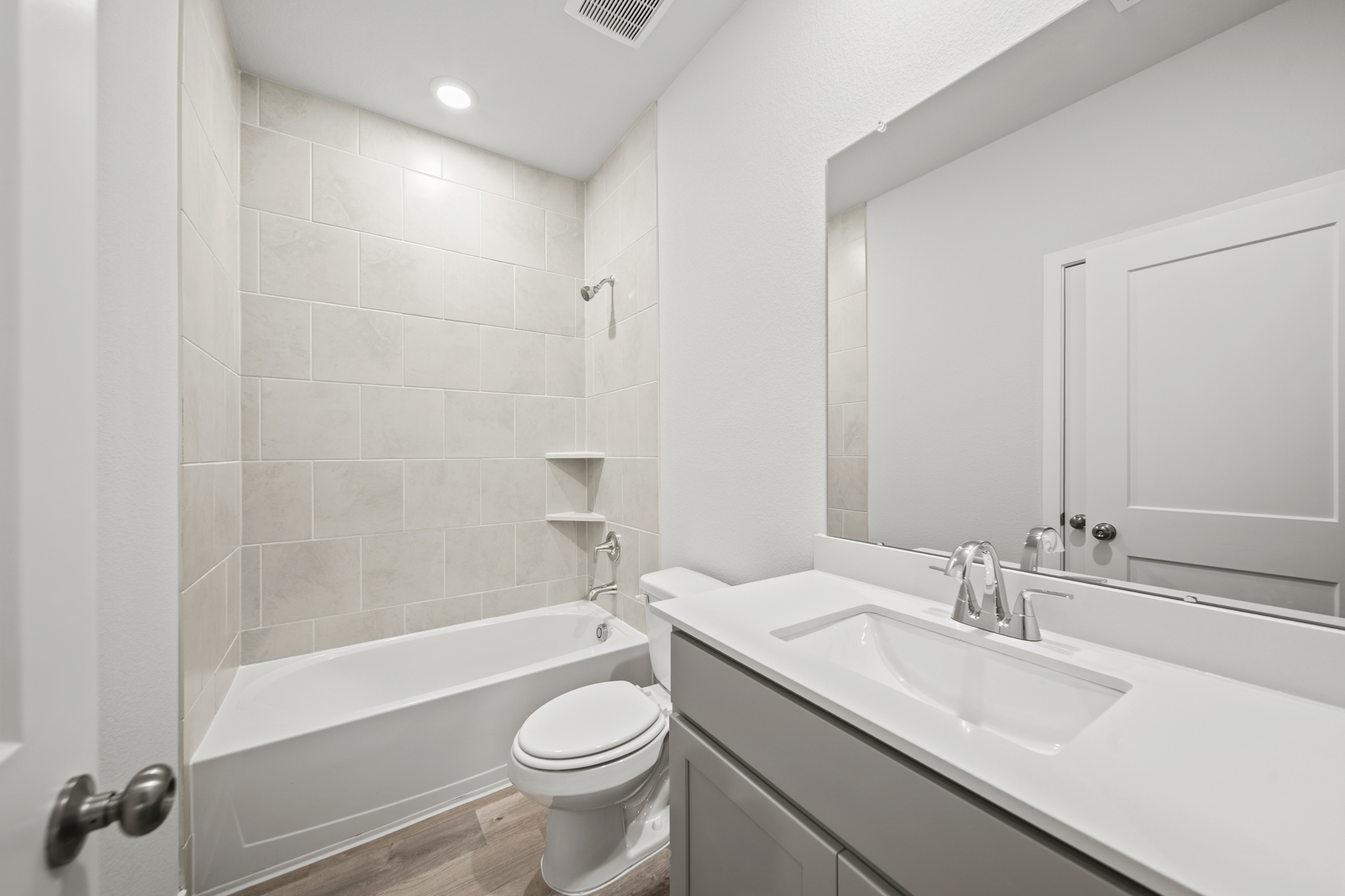 A bathroom with a tub sink and toilet.