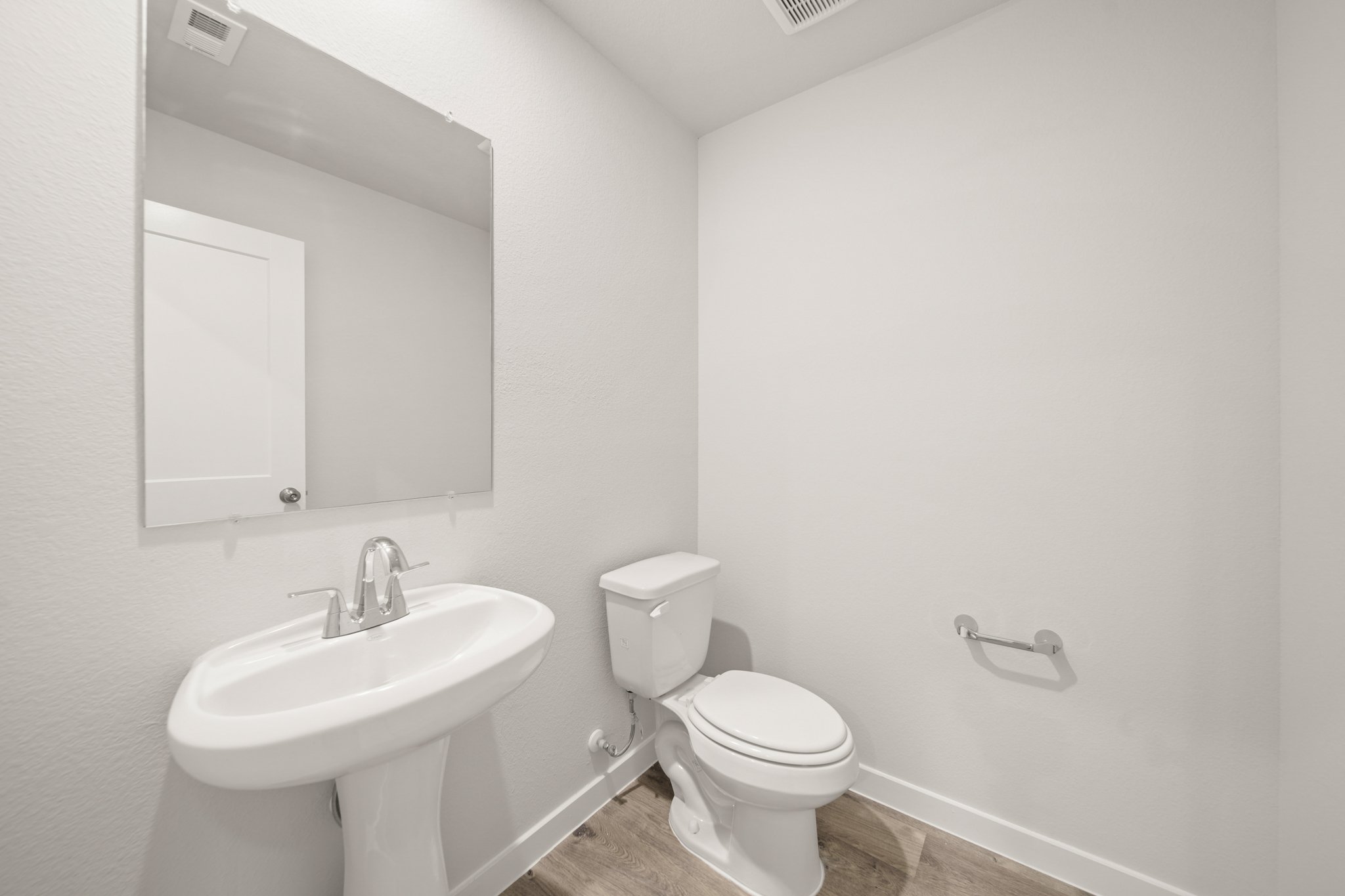 A bathroom with a toilet and sink.