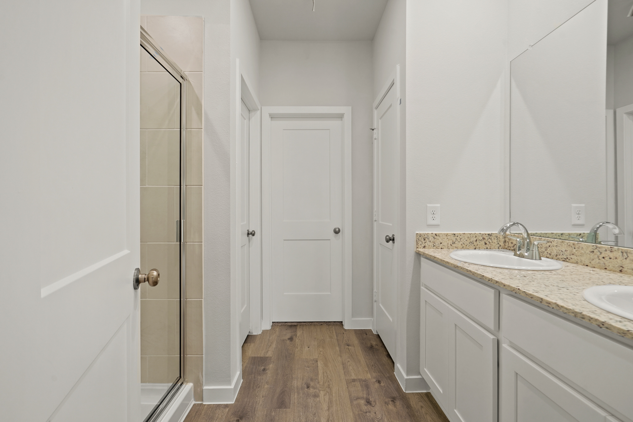 A bathroom with white cabinets.