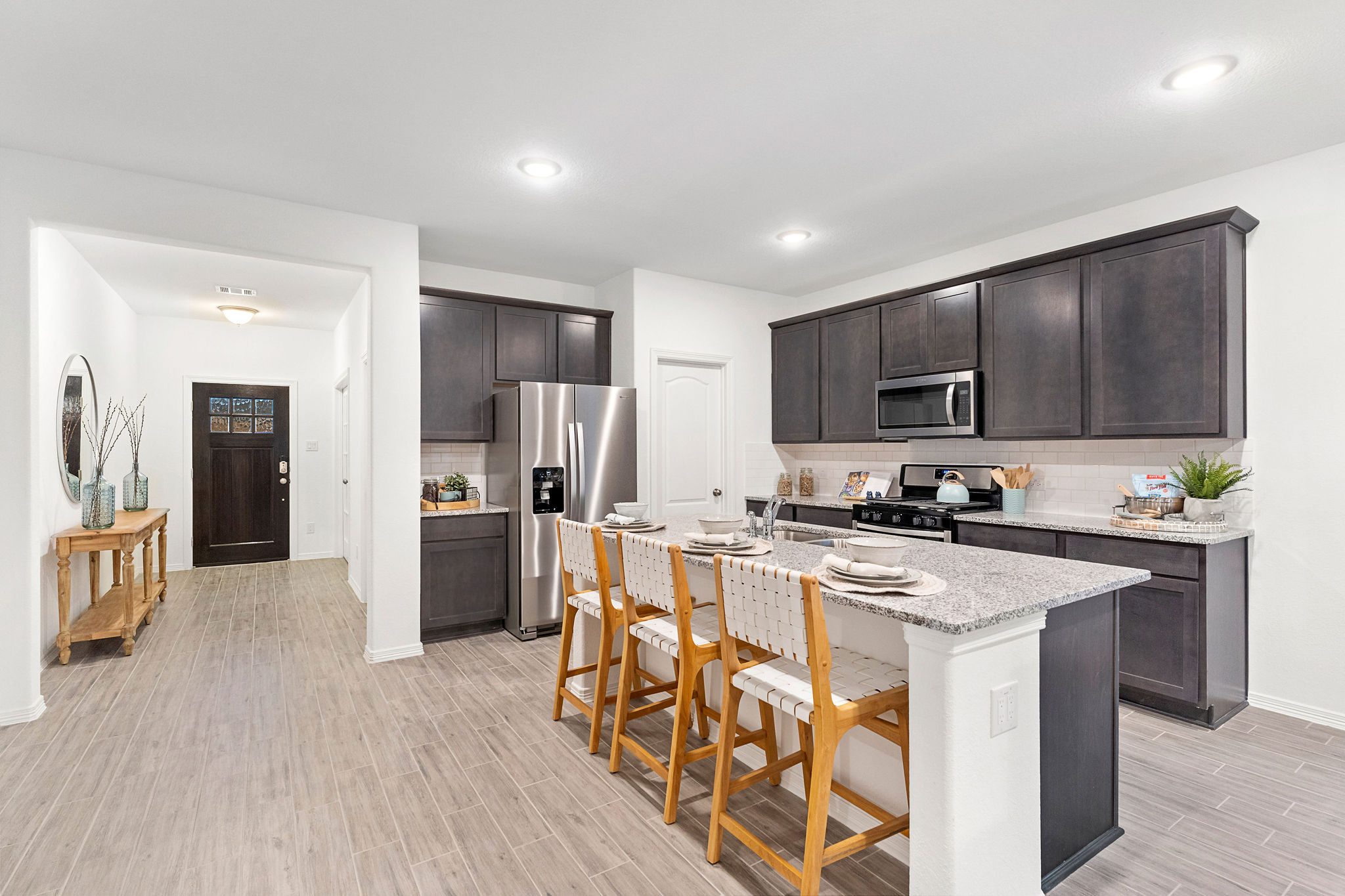 A kitchen with a wood floor.