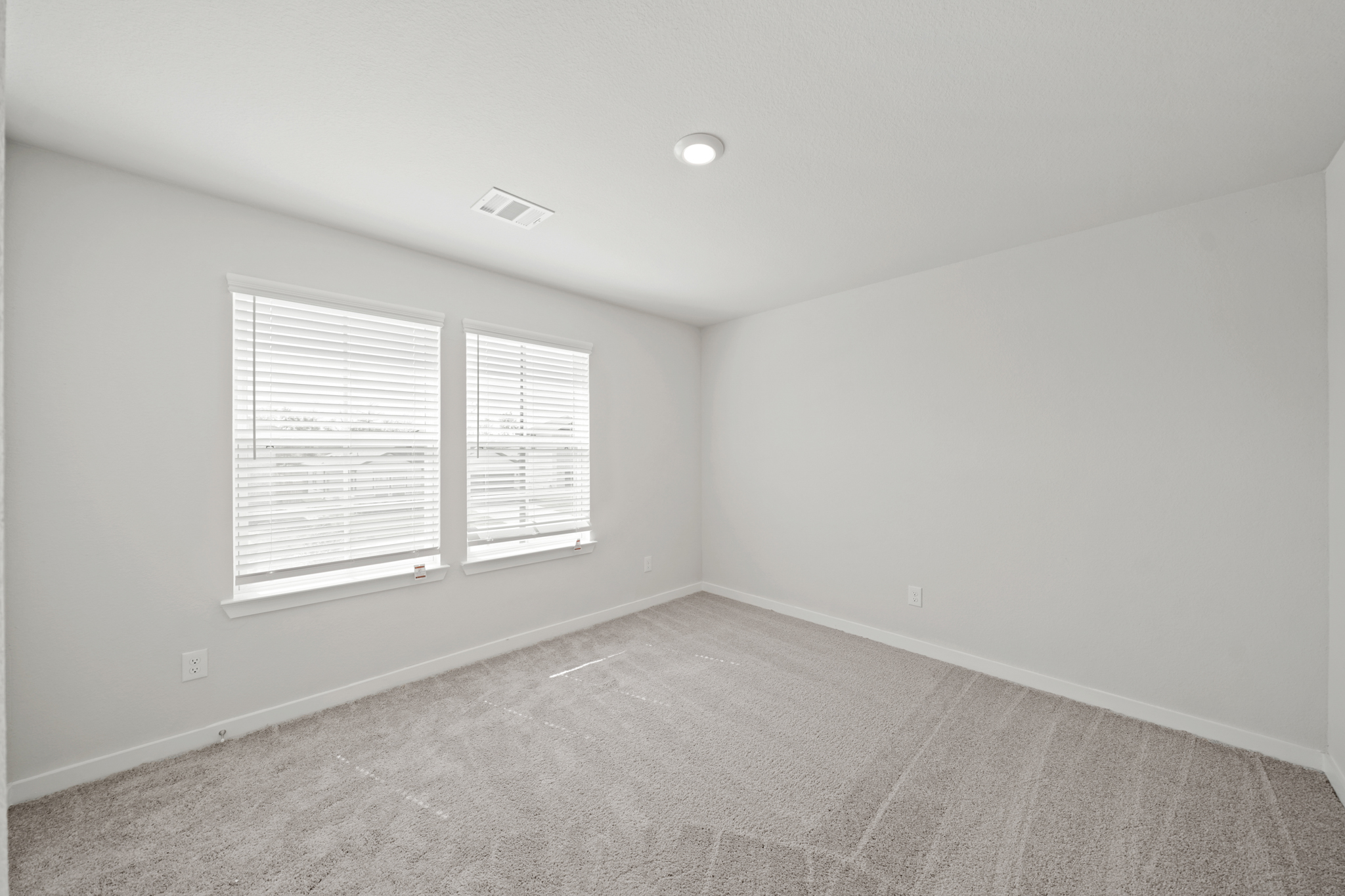 A room with a window and a carpet.