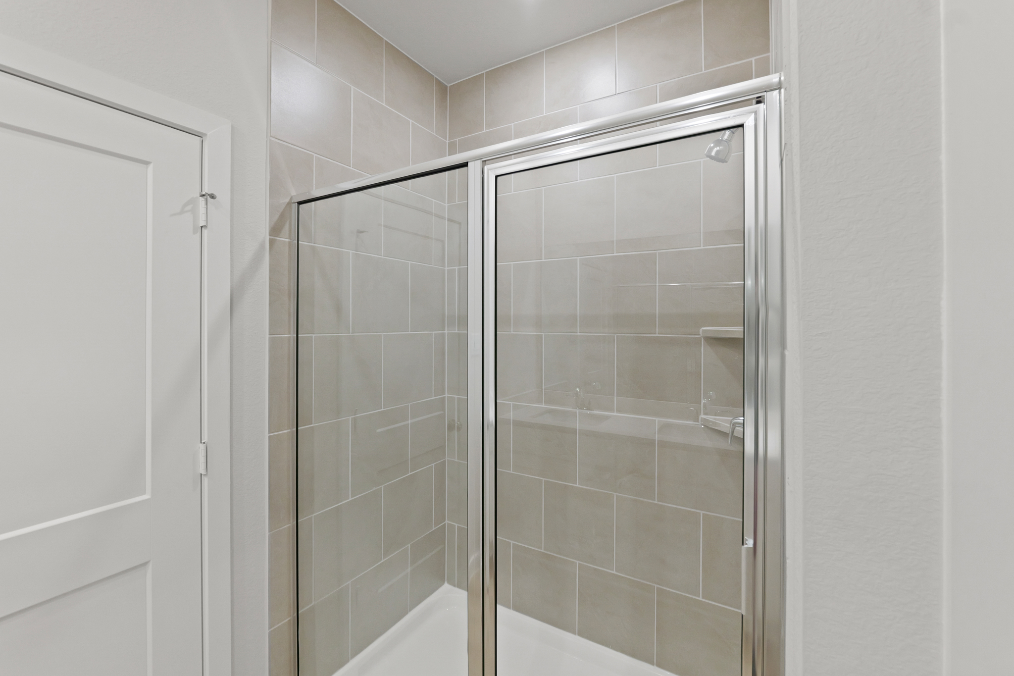 A shower with glass doors.