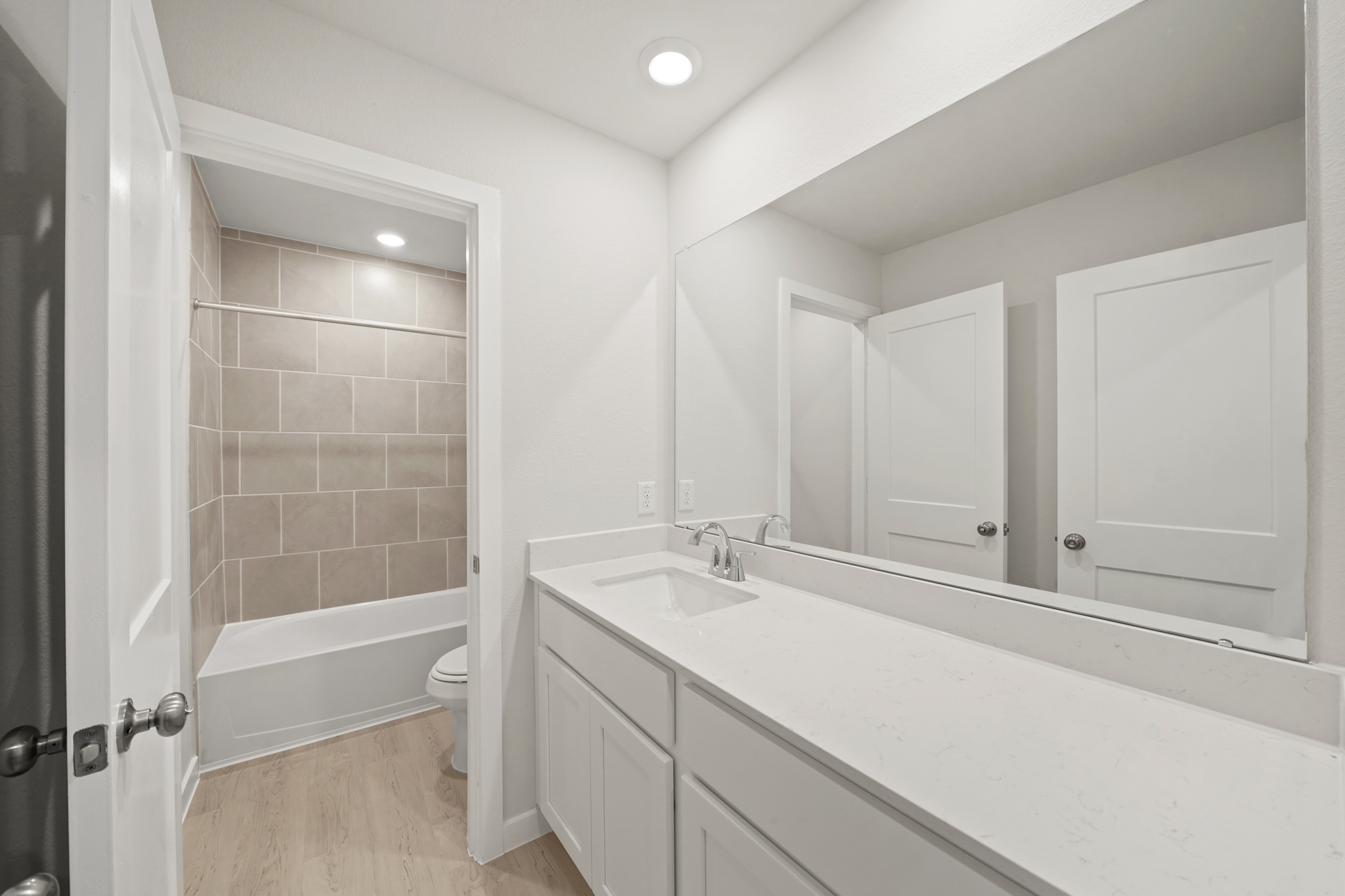 A bathroom with a tub sink and toilet.