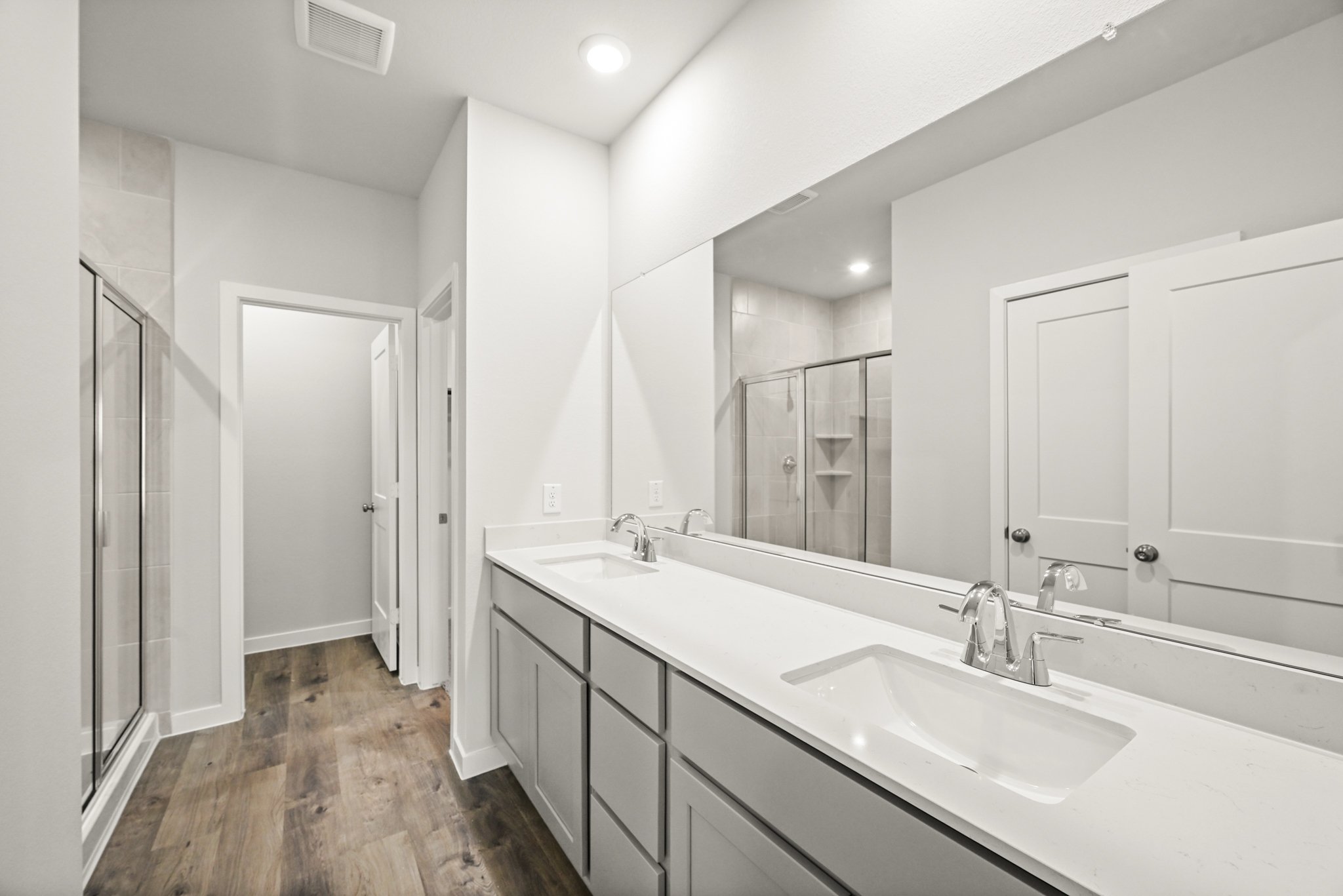 A bathroom with a large mirror.