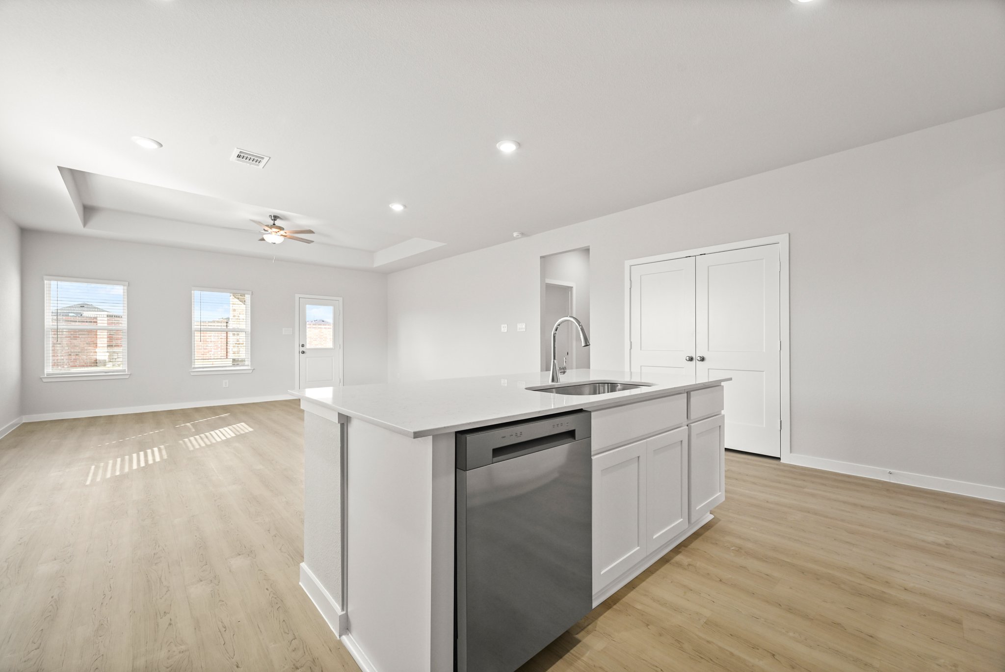 A kitchen with white cabinets.