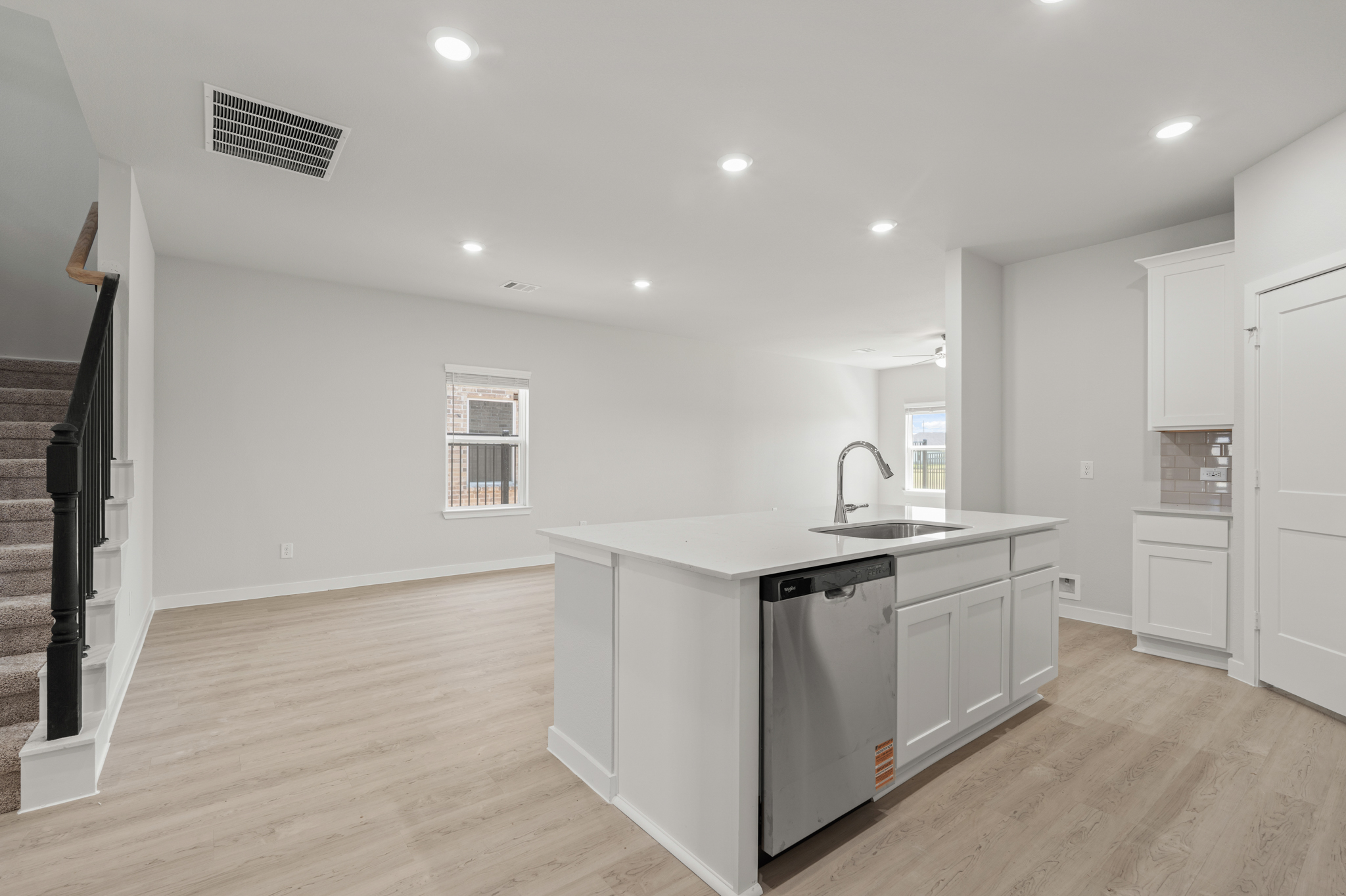 A kitchen with white cabinets.