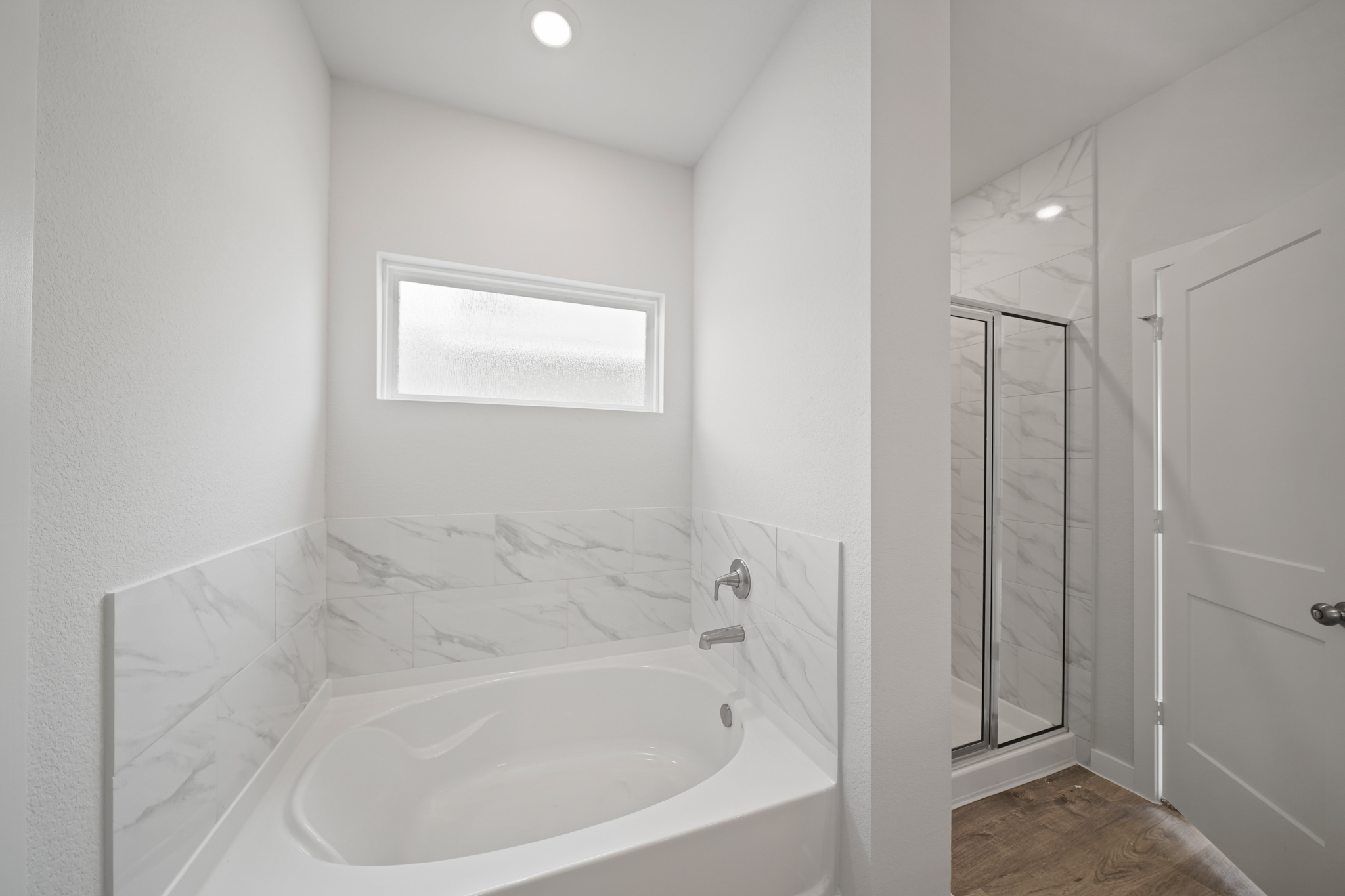 A bathroom with a tub and sink.
