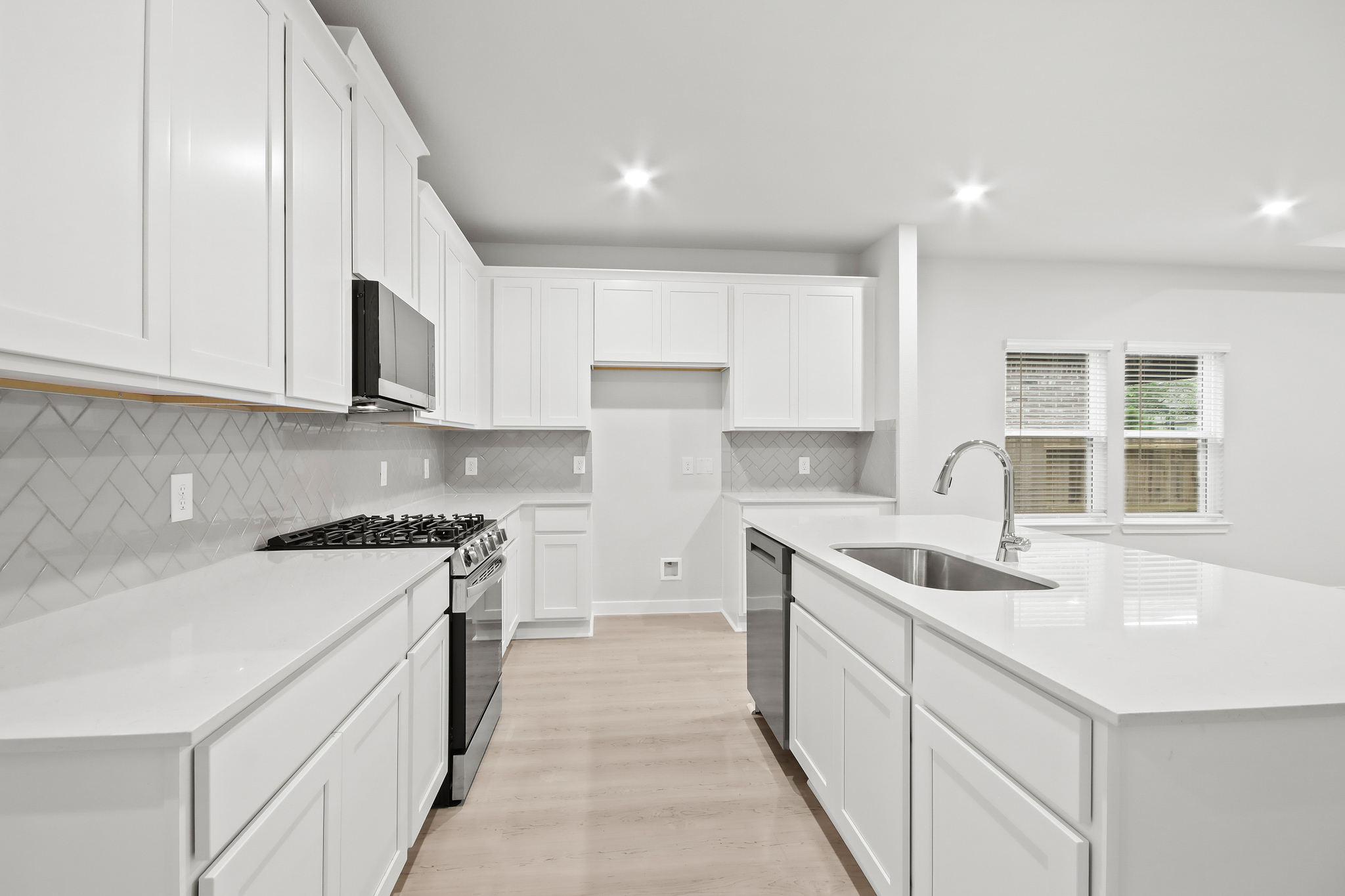 A kitchen with white cabinets.