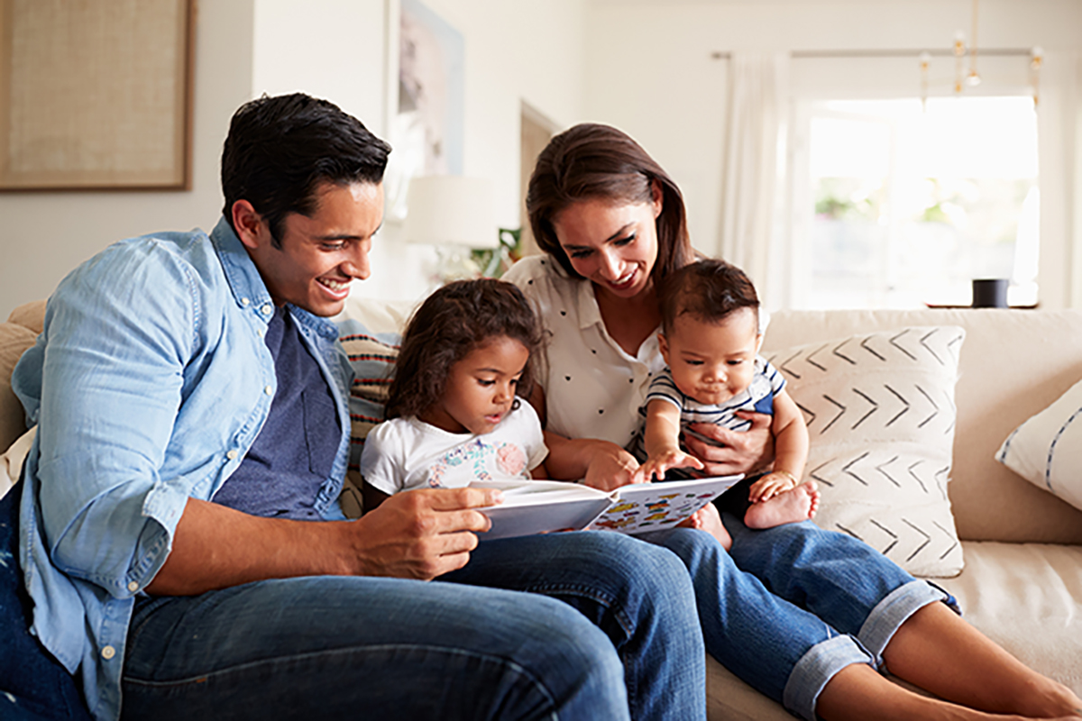 A family reading a book together.