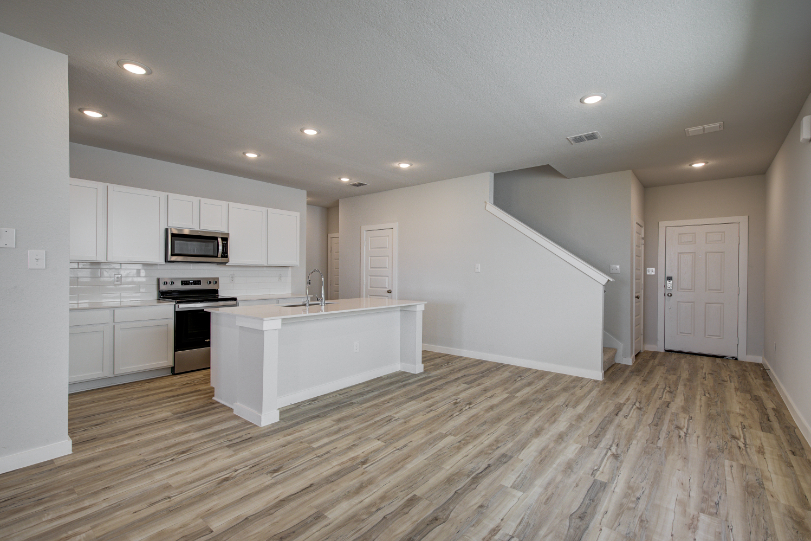 A kitchen with white cabinets.