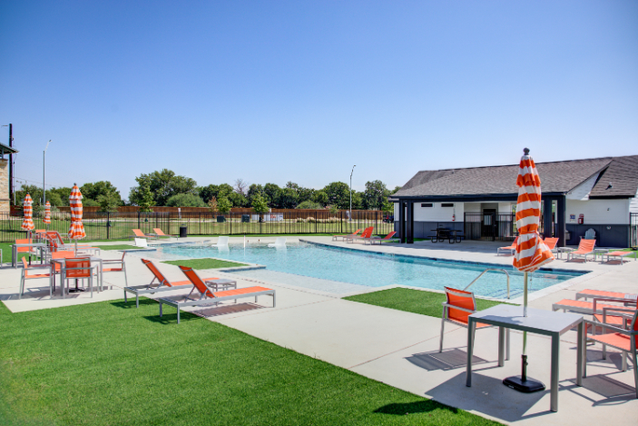 A swimming pool with a lounge chair.