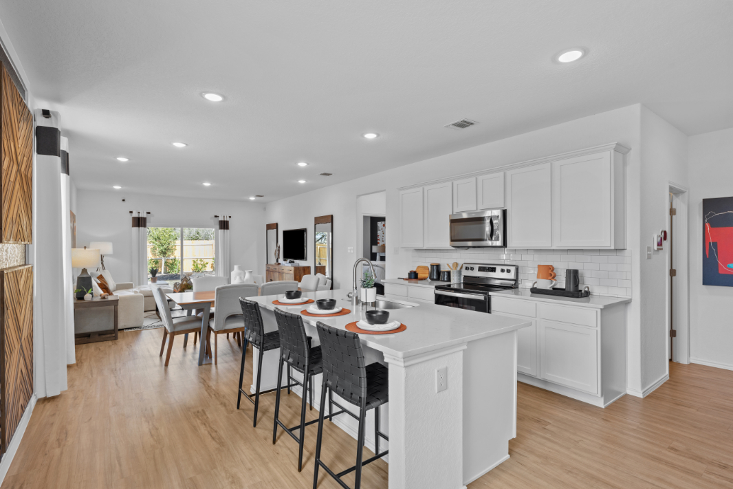 A kitchen with white cabinets.