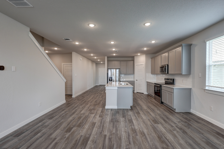 A kitchen with white cabinets.