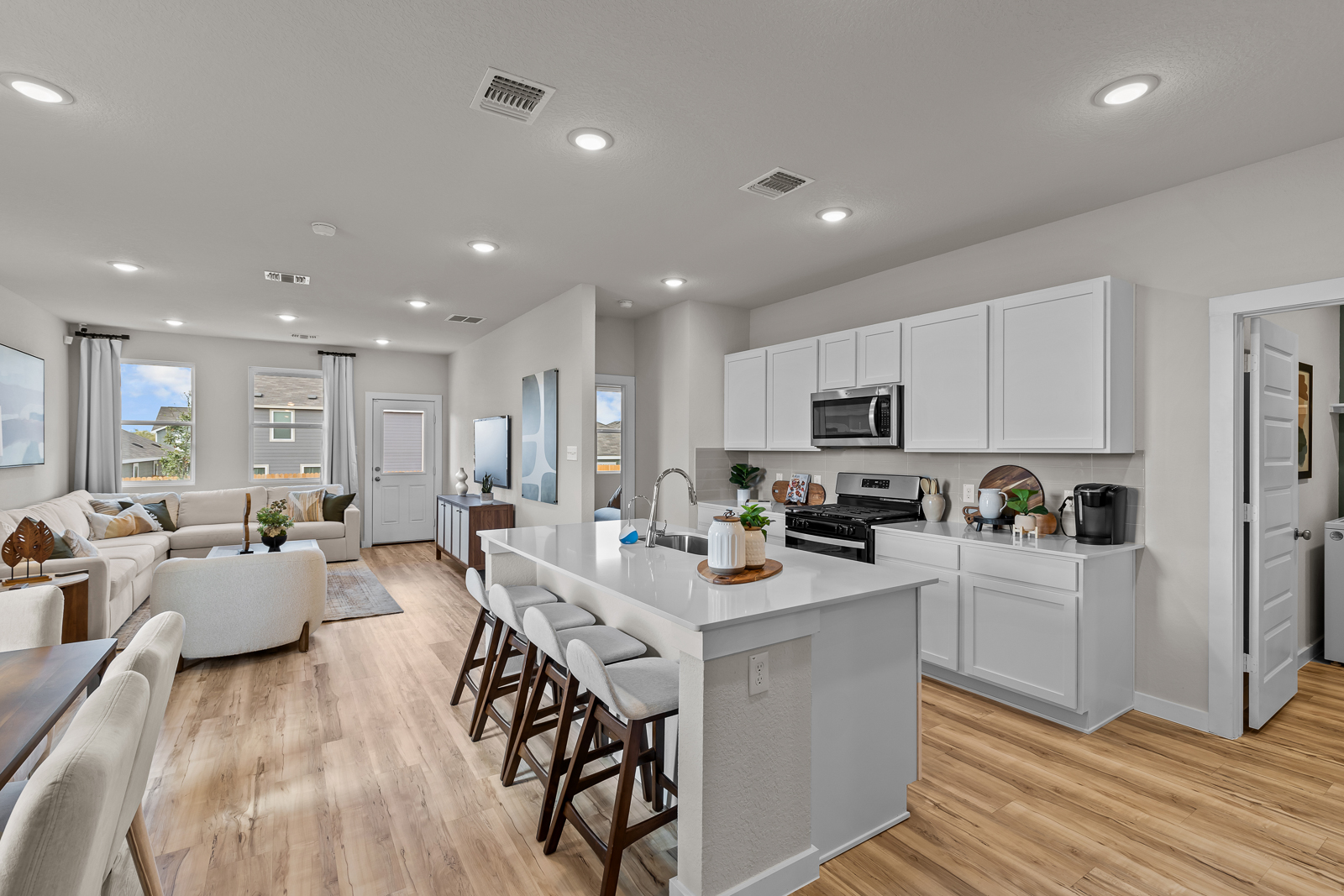A kitchen with white cabinets.