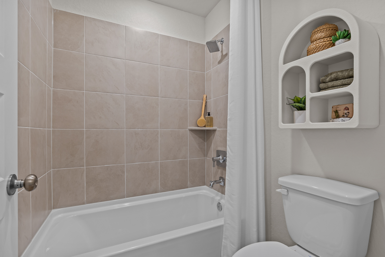 A bathroom with a tub toilet and sink.