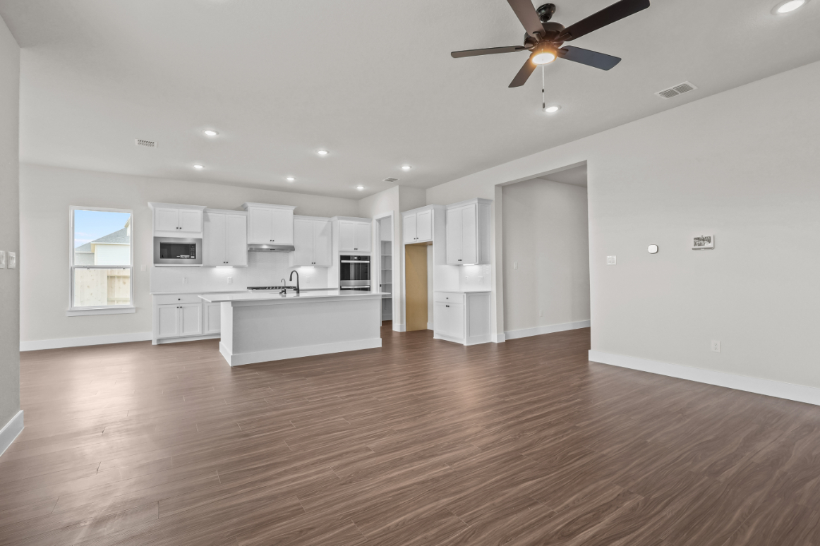 A large kitchen with white cabinets.