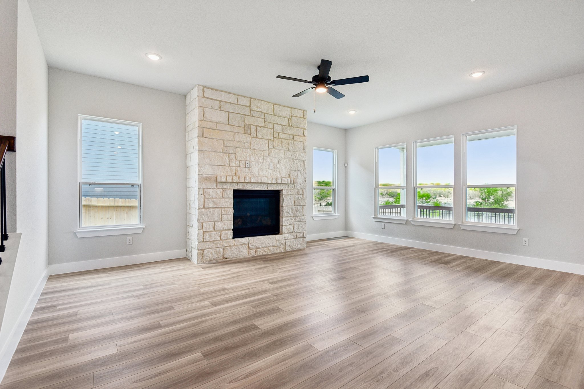 A room with a fireplace and a wood floor.