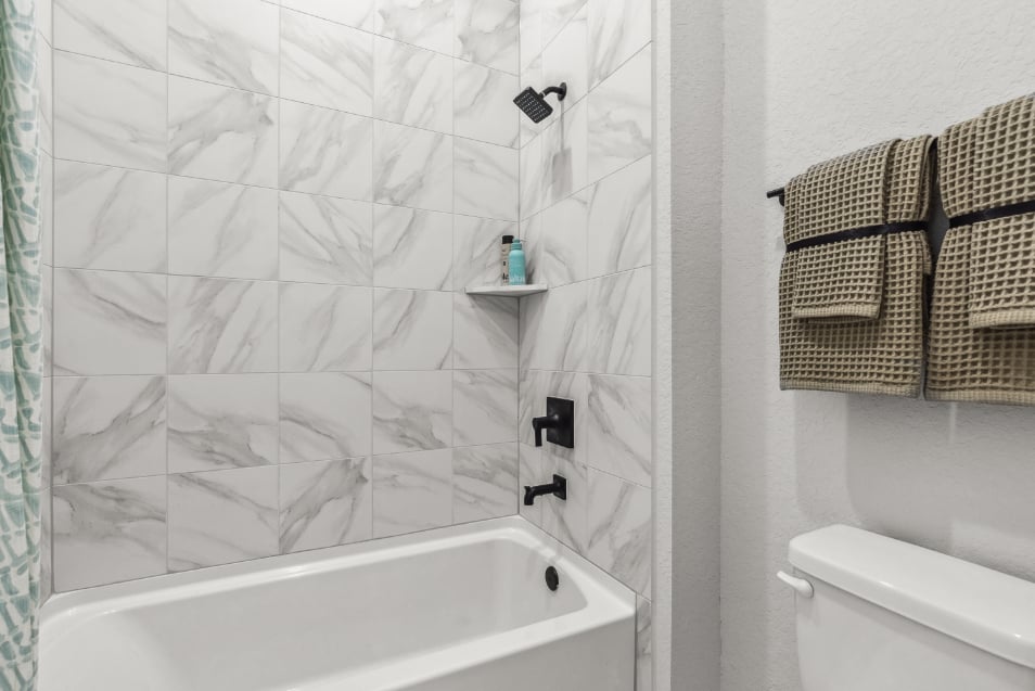 A bathroom with a shower and toilet.