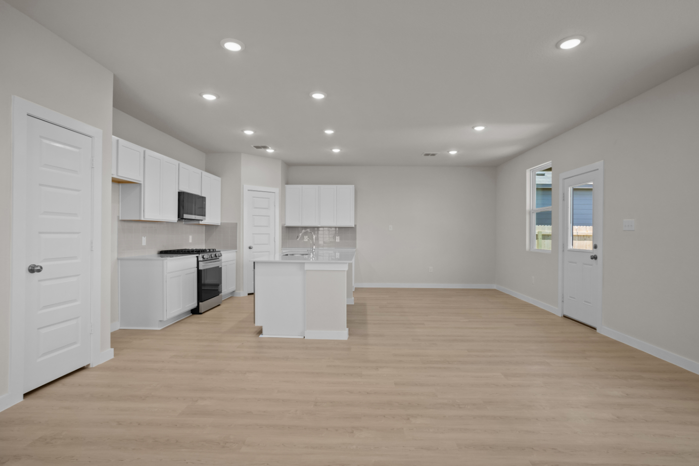 A kitchen with white cabinets.