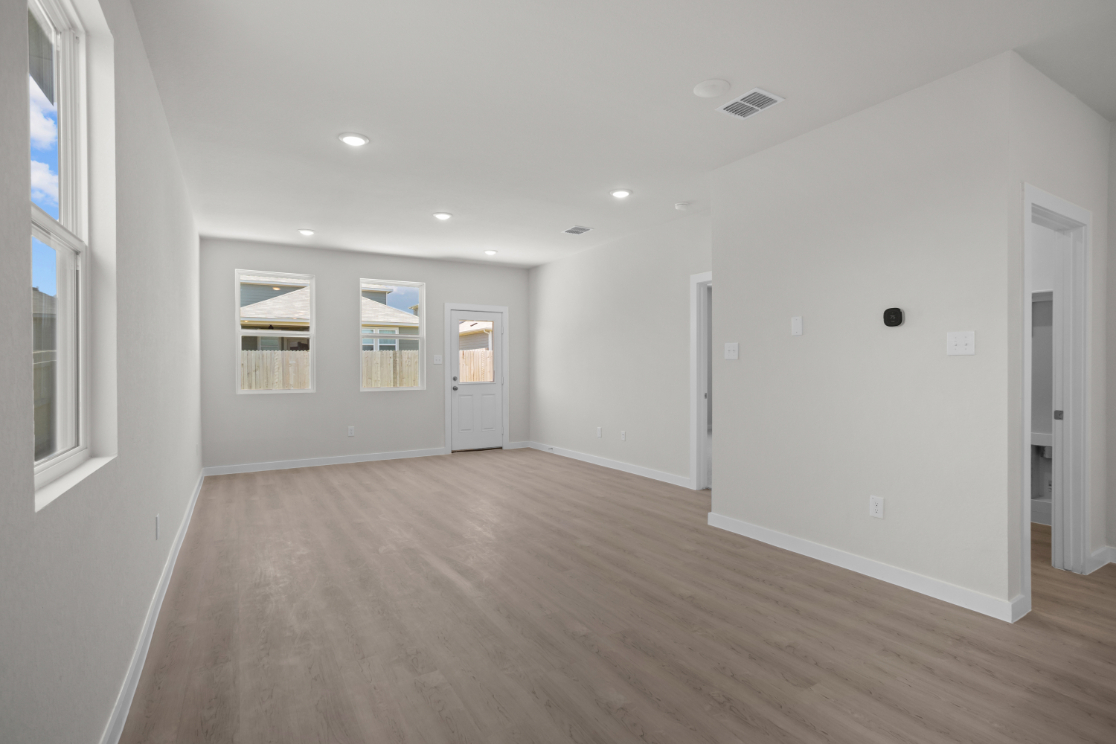 A room with white walls and wood floors.