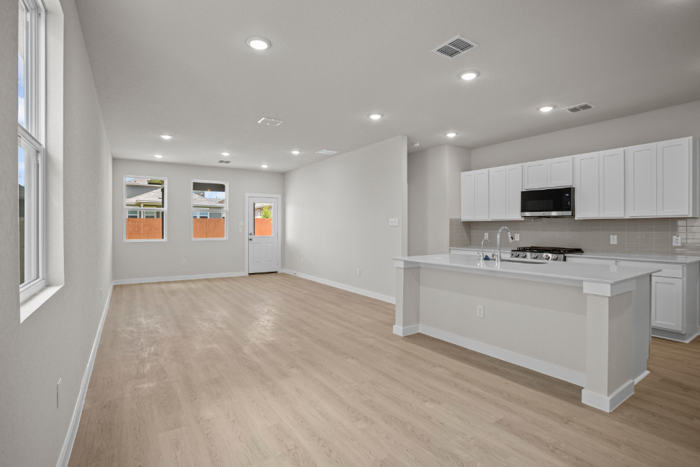 A kitchen with white cabinets.