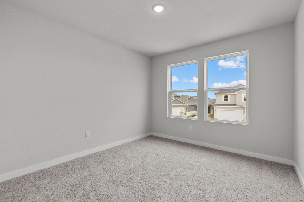 A room with a window and a carpet.