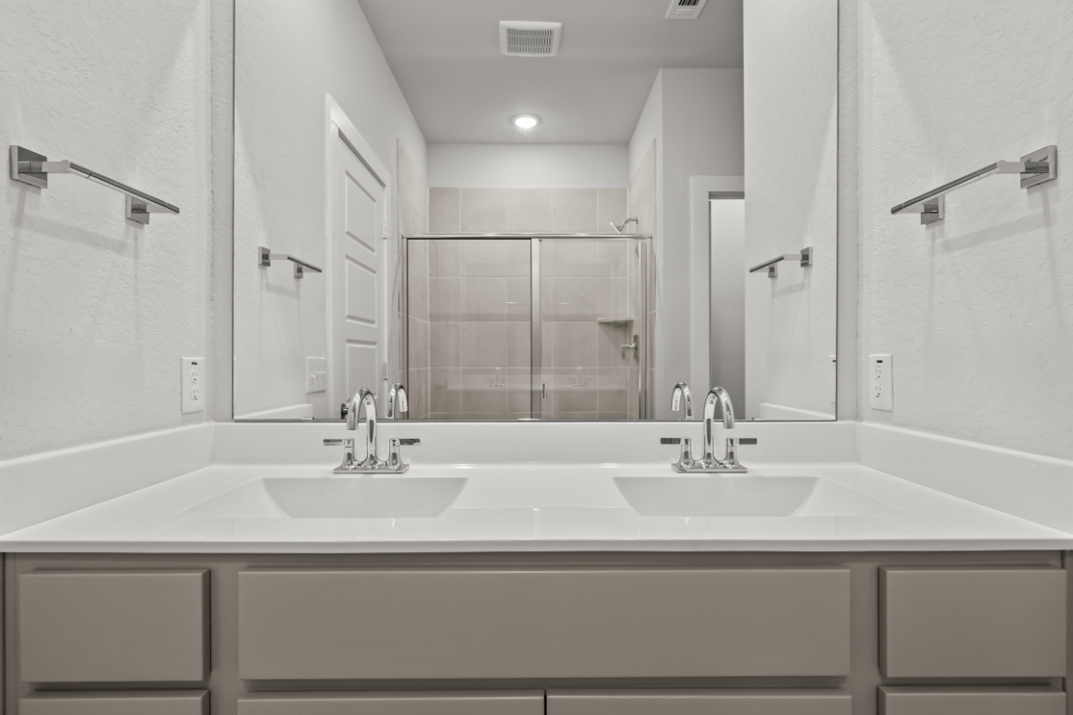 A bathroom with a large mirror.