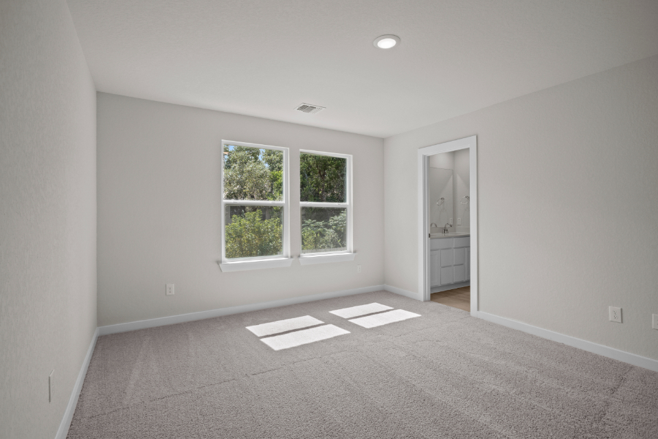 A room with a window and a rug.