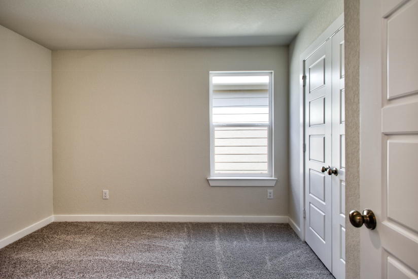 A room with white doors and a window.