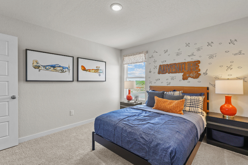 A bedroom with a bed and lamps.