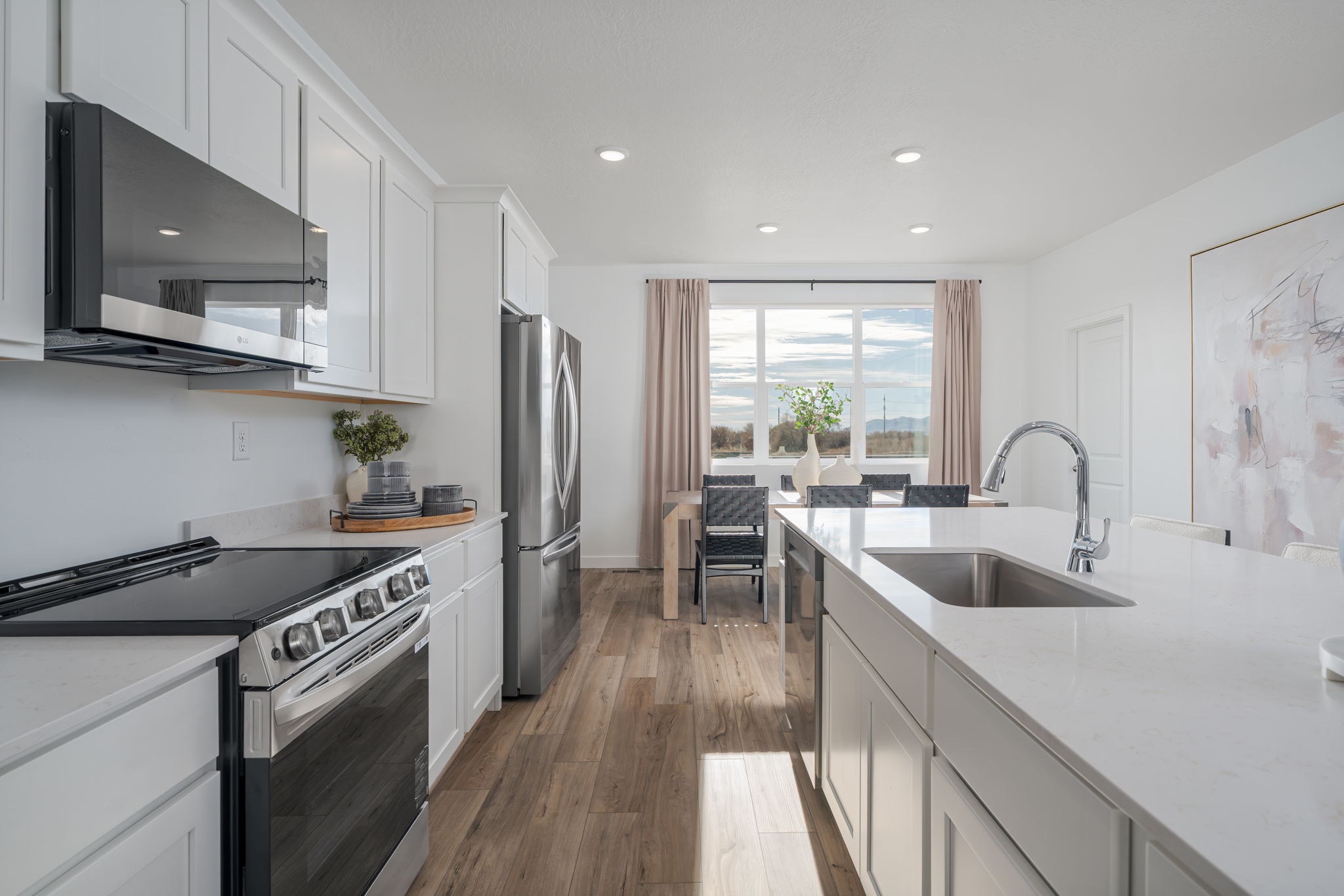 A kitchen with white cabinets.