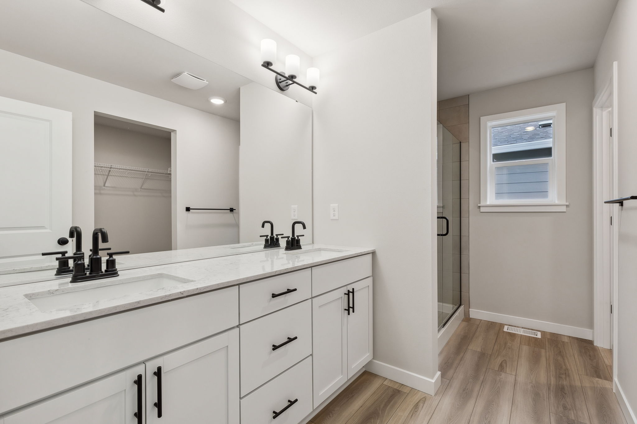 A bathroom with white cabinets.