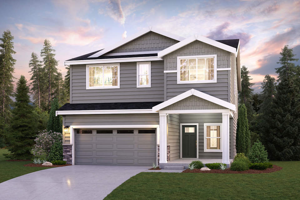 A house with a garage and trees around it.