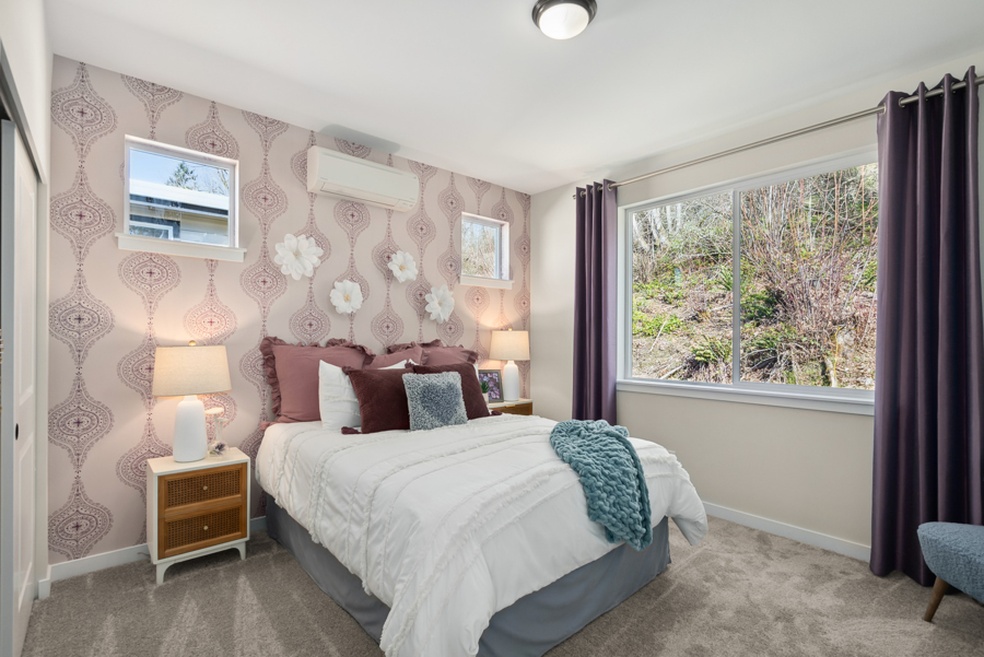 A bedroom with a bed and a window.