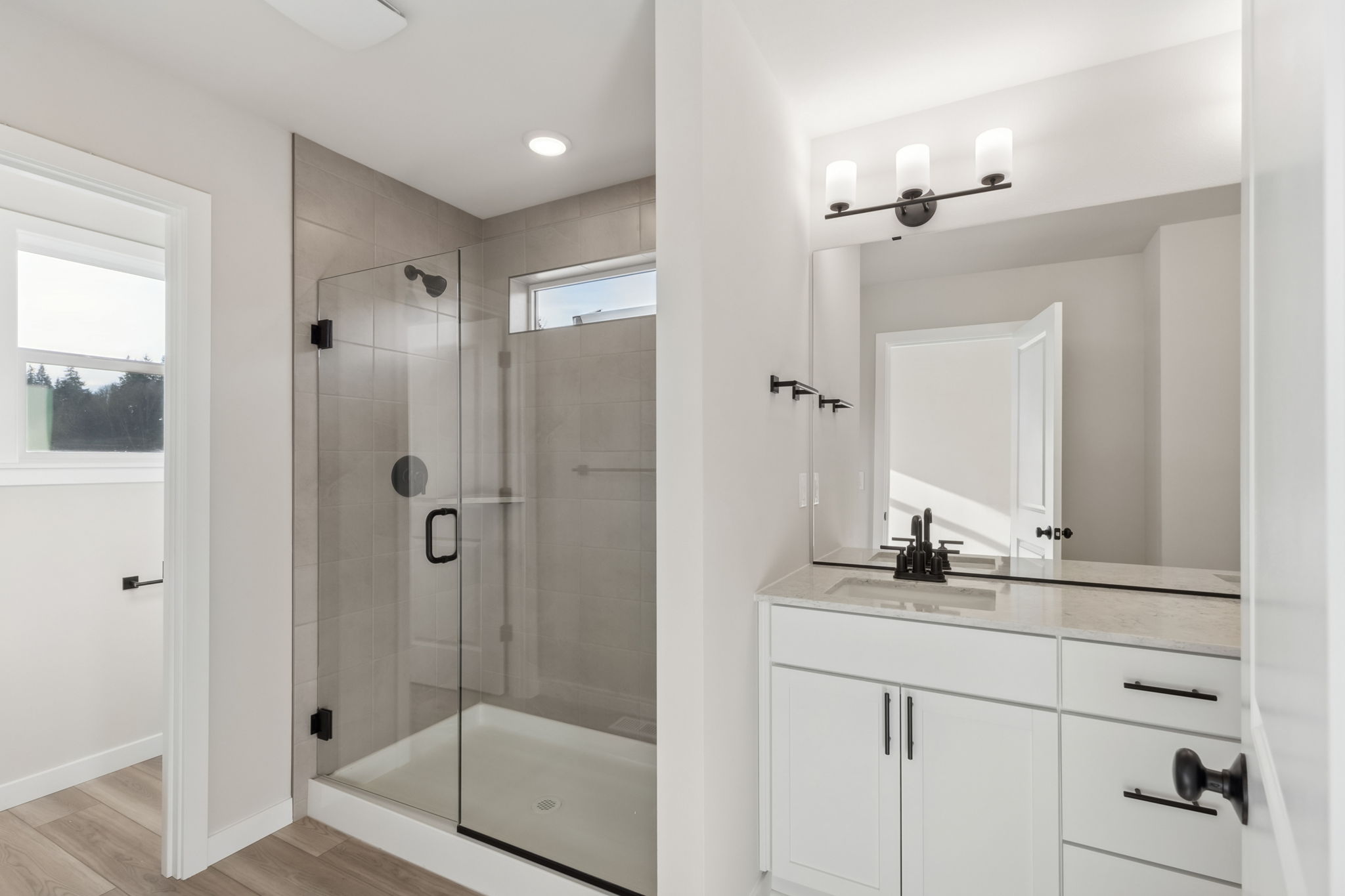 A bathroom with a shower and sink.