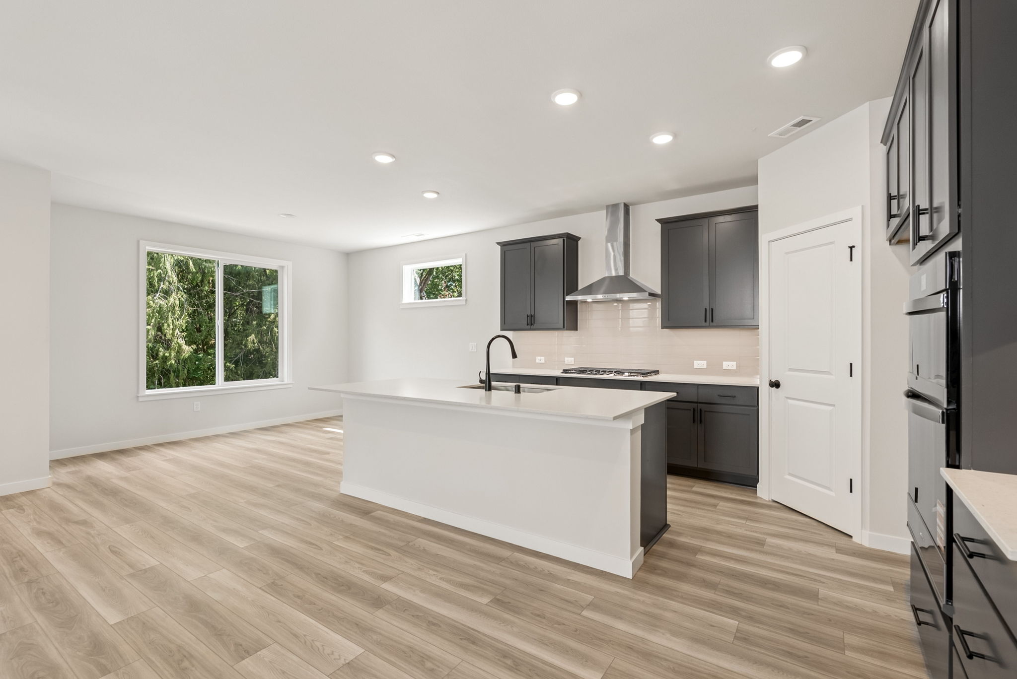 A kitchen with white cabinets.