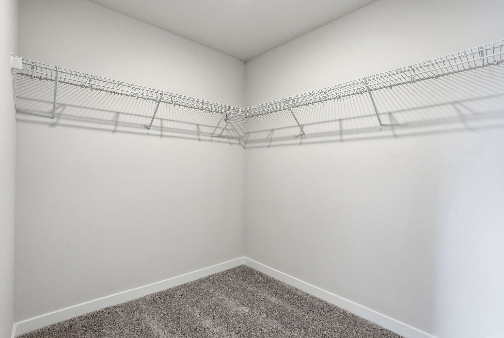 A white room with a metal railing.
