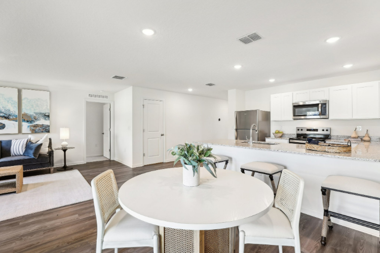 A kitchen with a dining table.