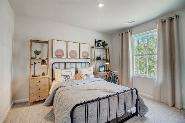 A bedroom with a bed and a shelf with a window.
