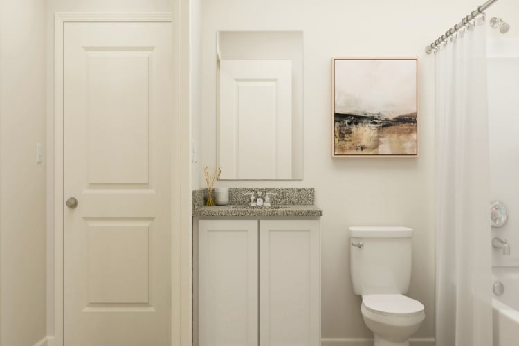 A bathroom with a sink toilet and a shower.