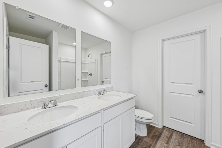 A bathroom with a large mirror.