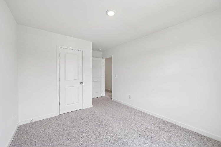 A hallway with white doors.