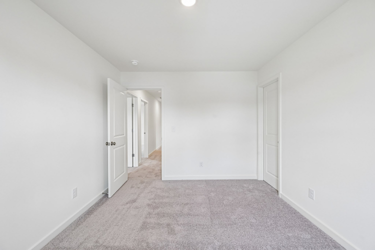A hallway with white doors.