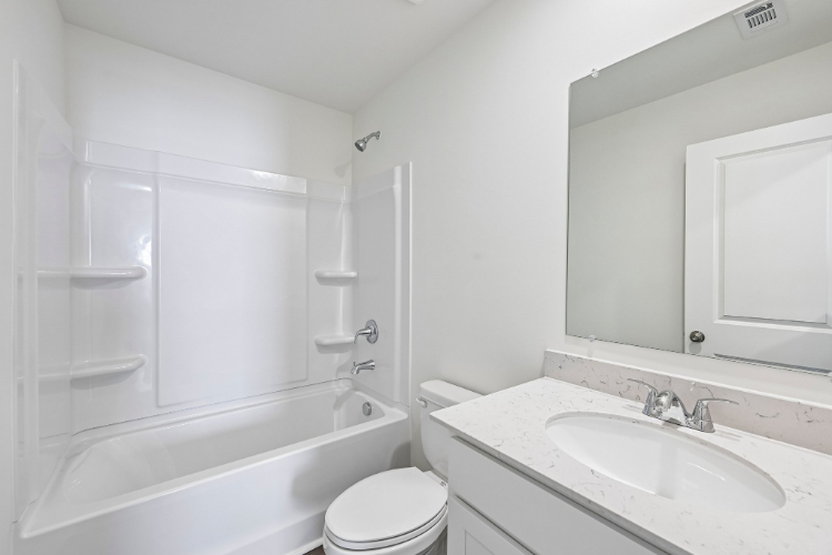 A bathroom with a sink toilet and bathtub.